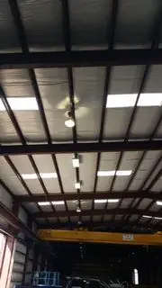 Warehouse ceiling with steel purlins and high-bay fixtures