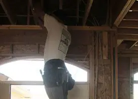 Light fixture being fitted to a timber ceiling