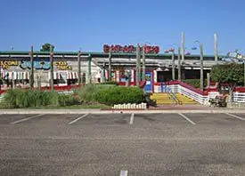 Retail strip with sign and lot lighting