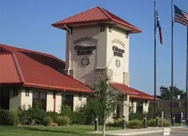 Civic building with a clock tower and flagpoles